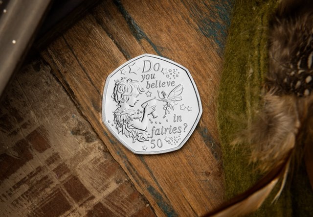 The 2020 Official Peter Pan 50p Coin on wooden surface
