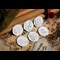 The 2020 Official Peter Pan 50p Coin Set Reverses leaning against wooden surface
