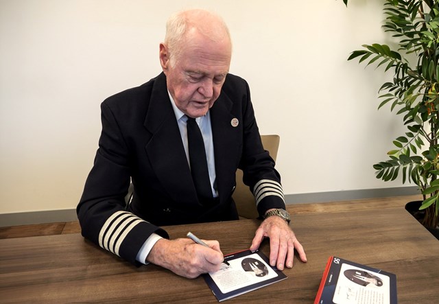 Jock Holding Signing The Masterpiece Booklets